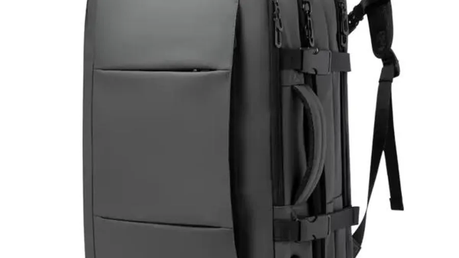 Backpack with side compression straps, top handle, and attachment points visible